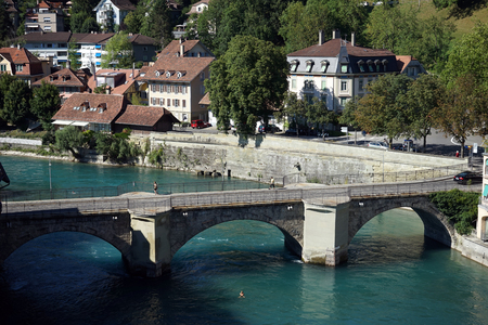BERN, SWITZERLAND - CIRCA AUGUST 2015 Embankment of Aare river and stone arch bridgeのeditorial素材