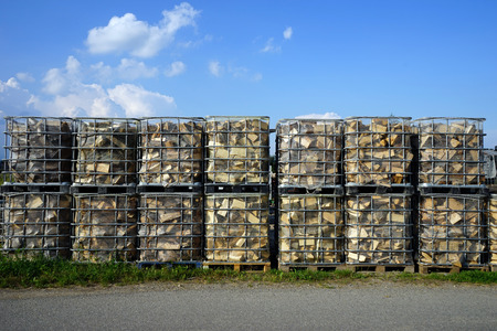 Asphalt road near boxes with firewood in Germanyの写真素材