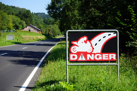 Road sign danger for motorbikeの写真素材