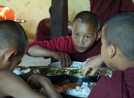 KALAW, MYANMAR - CIRCA APRIL 2017 Young monks near the tableのeditorial素材