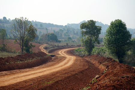 Dirt road on the red soil in Myanmarの写真素材