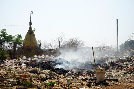 Big garbage with rubbish near dagoba in Myanmarの写真素材