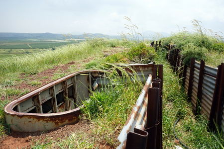 Old trench and green grass in Golan Heights in Israelの写真素材