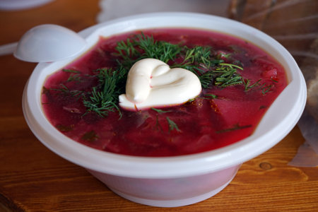 Plate with borsh soup on the table