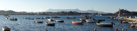 CORFU, GREECE - CIRCA MAY 2019 Boats in bay and fortress