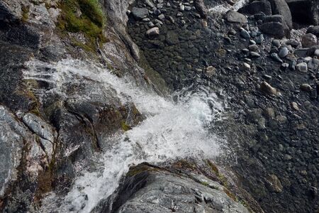 Waterfall and rock in mountain area of Norwayの写真素材