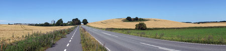 Panorama of farmland and asphalt road in Denmark
