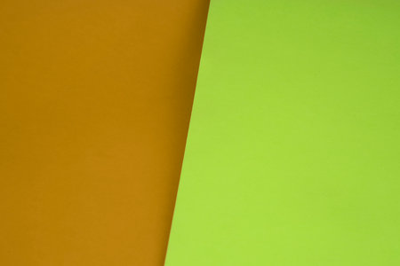 Colored paper background. Green, orange and brown tones. Copy space.の写真素材