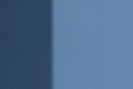 Abstract background. Shadow of the sun on a blue wall. Place for text.の写真素材