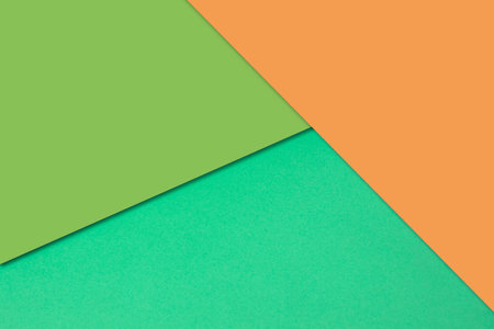 Green and orange paper background. Minimal geometric abstract design, flat lay.の写真素材