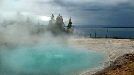 Geyser besides lake/ hot and coldの写真素材