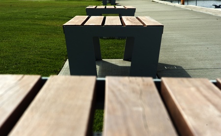 Simple benches in public park in spring.の写真素材