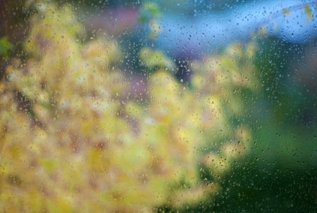 Water drops on window glass surface with scenic backgroundの写真素材