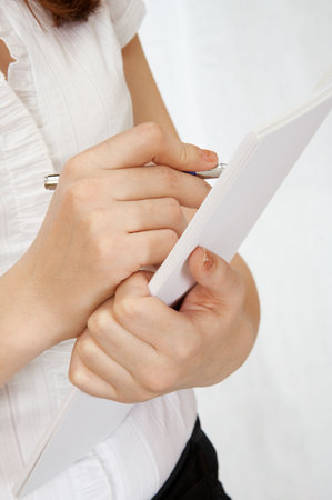 Hand of the woman signing the document