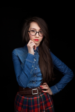 A young cute woman on a dark backgroundの写真素材
