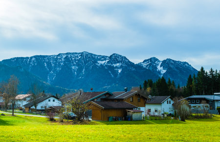Austrian alps, Green meadows, alpine cottages and mountainsの写真素材