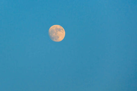Glowing super full Moon in to the dark blue sky