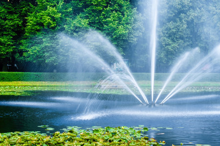 Beautiful fountain in lake at the park. Splashing streamsの写真素材