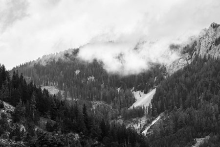 Alps mountains in stormy clouds, in black and white