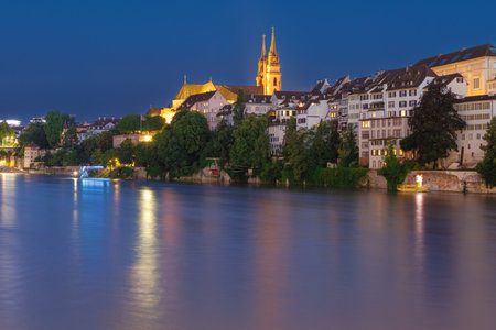 A bridge over a river with a yellow flag flying. The scene is at night and the water is calmの写真素材