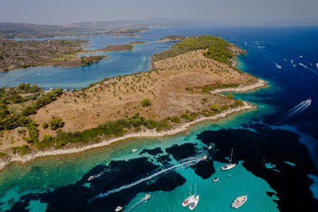 Aerial shot of a coastal landscape with clear blue waters. Mediterranean Greek islands