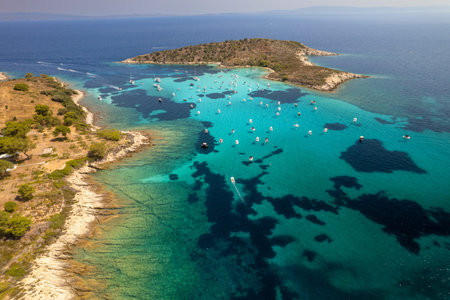 Aerial shot of a coastal landscape with clear blue waters. Mediterranean Greek islands