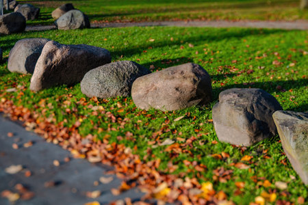 view of big stones and autumn leaves on the groundの写真素材