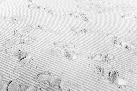 footprints on white grooved surface in black and whiteの写真素材