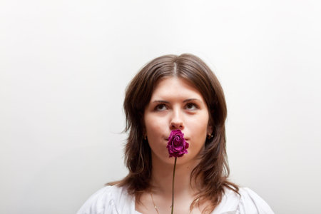 dreaming young woman with flower on white background