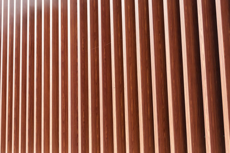 Wooden vertical slats on a wall background. Interior detail, texture, background. The concept of...