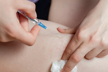 Close up of a Doctor hands with syringe prepare to make injection to a patientの写真素材