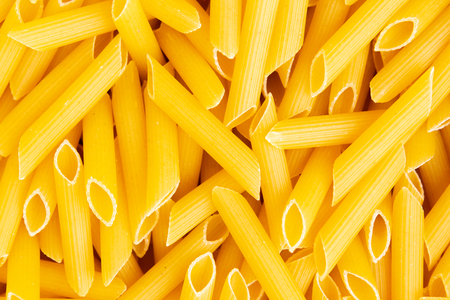 Italian Penne Rigate Macaroni Pasta raw food background or texture close up, top view.の写真素材