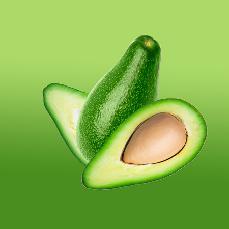 Two slices of avocado on color green background. One slice with core. top view, closeup, collageの写真素材