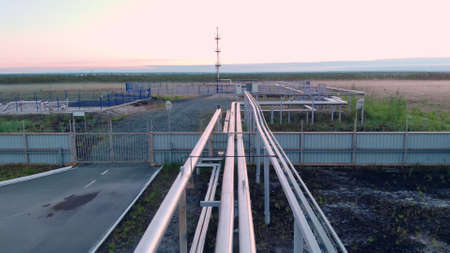 A drone flies over a pipeline, a gas pipeline at an oil and gas field in Siberia. Natural gas reserves in Russia or Canada. Rising gas prices in the world.の写真素材