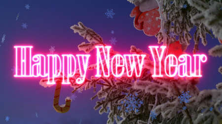 Christmas tree decorated with toys, snowflakes fall down, the inscription of a happy new year appears. Screensaver or postcard with visual effects. Christmas mood.の写真素材