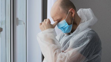 The face of a male doctor in a rest room in a mask, a paramedic looks into the frame, a man with a...