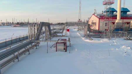 Winter oil and gas refinery plant in siberia. The drone flies over the gas pipeline feeding the gas turbine power plant. World energy crisis. Green Energy Program to Solve Fossil Fuel Problemsの写真素材
