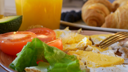 Close-up breakfast, a full breakfast with scrambled eggs with vegetables, croissants, fruits,...