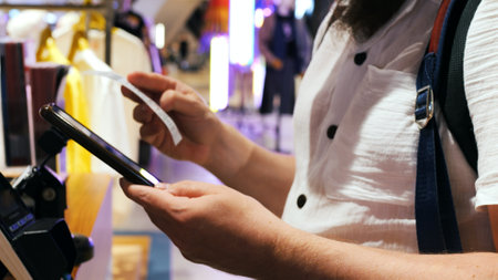 Cinematic video: man pays for purchases at the checkout using a QR code. The buyer pays for goods in the store using a QR code. Concept: pay for purchases at the checkout using a QR code to save time.の写真素材