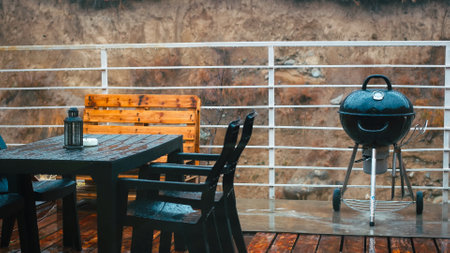 Cozy Backyard for BBQ and Relaxation in Rain. Enjoy the tranquility of a comfortable backyard as raindrops create a soothing ambiance. Discover the charm of a cozy backyard under the rainの写真素材