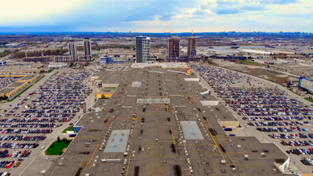 Drone view showcasing bustling shopping center parking lot with neatly lined cars. sweeping over busy parking lot of shopping center, epitomizing urban convenience. at parking lot of shopping centerの写真素材