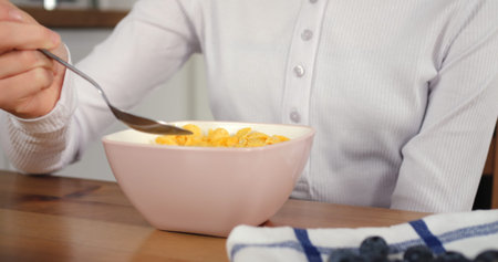 Childs breakfast of cereal and milk fuels her morning Girls breakfast is nourishing routine in calm...