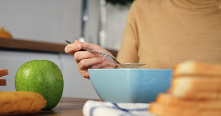 Woman enjoys cereal for healthy breakfast cinematic close-up slow-motion natural products in healthy...