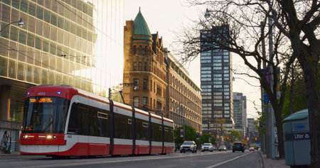 Toronto, Canada - May 6, 2023: Tram seamlessly blends city architecture enhancing urban landscape...