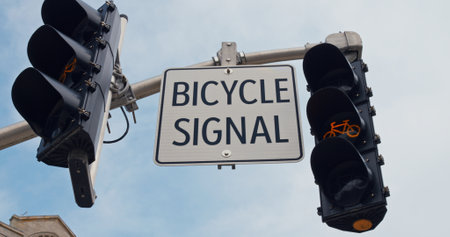 Bicycle sign coupled with a cyclist-specific signal light underscores the cities commitment to safe and efficient urban biking pathways. urban transport regulation. Bike-focused city scene.の写真素材