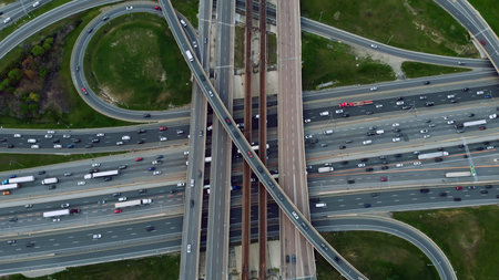 Metropolitan arteries pulsing with cars, aerial showcase of urban pace. Transportation web: Aerial...