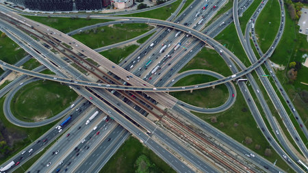 Aerial highway interlacing, rush hour traffic, urban dynamics captured. Traffic tapestry:...