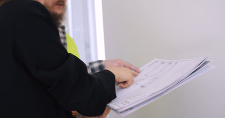 Builder and client engage in detailed planning for home interior. Strategic session highlights...