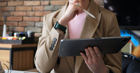 Marketing professional focused on tablet, analyzing audience insights and market trends....