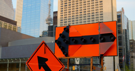 Urban roadwork scene with bright warning signs and traffic detours showcases vibrant city life, emphasizing navigation and safety in the midst of dynamic downtown construction projects.の写真素材
